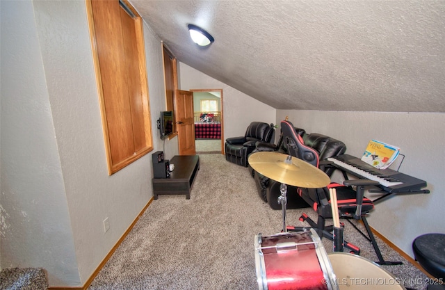 game room with carpet flooring, a textured ceiling, baseboards, lofted ceiling, and a textured wall