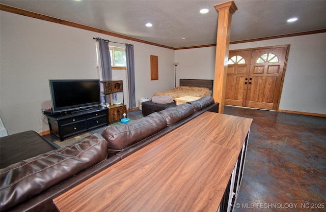 living area with finished concrete flooring, recessed lighting, ornate columns, ornamental molding, and baseboards