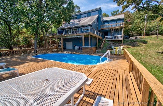 pool featuring a yard, stairway, and a deck