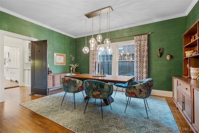 1225 E 18th St, Tulsa, OK 74120 - dining space with wallpapered walls, wood finished floors, crown molding, and a chandelier