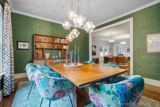 1225 E 18th St, Tulsa, OK 74120 - dining space with wallpapered walls, dark wood-style flooring, baseboards, crown molding, and a chandelier