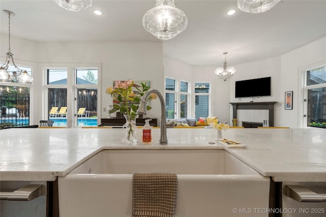 1225 E 18th St, Tulsa, OK 74120 - kitchen featuring open floor plan, a sink, a chandelier, recessed lighting, and a fireplace