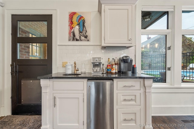1225 E 18th St, Tulsa, OK 74120 - bar featuring refrigerator, a sink, decorative backsplash, and dark wood-style floors