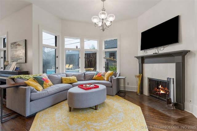1225 E 18th St, Tulsa, OK 74120 - living room featuring a chandelier, dark wood-style floors, and a fireplace