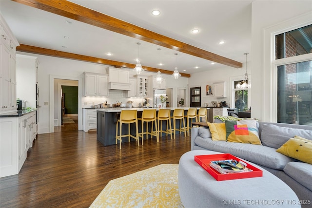 1225 E 18th St, Tulsa, OK 74120 - living room with beamed ceiling, dark wood-type flooring, and recessed lighting
