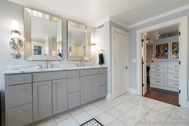 1225 E 18th St, Tulsa, OK 74120 - bathroom featuring double vanity, crown molding, marble finish flooring, baseboards, and a spacious closet