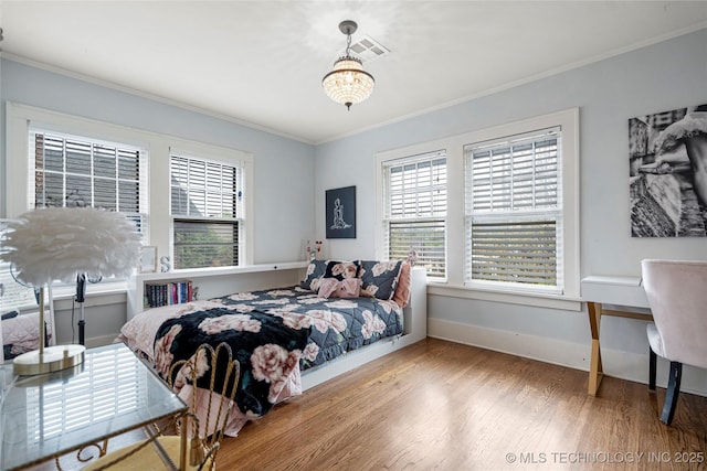 1225 E 18th St, Tulsa, OK 74120 - bedroom featuring crown molding, wood finished floors, baseboards, and a chandelier