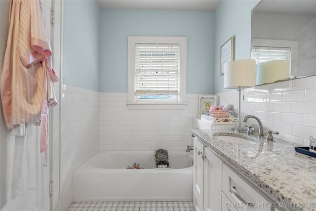 1225 E 18th St, Tulsa, OK 74120 - bathroom featuring vanity, a bath, tile walls, and a wainscoted wall