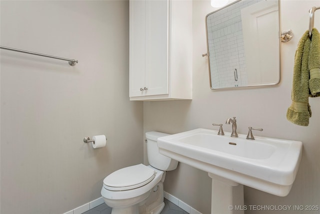 1225 E 18th St, Tulsa, OK 74120 - half bathroom with baseboards, toilet, a sink, and tile patterned flooring