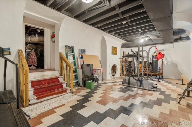 1225 E 18th St, Tulsa, OK 74120 - finished basement featuring tile patterned floors, arched walkways, and stairway