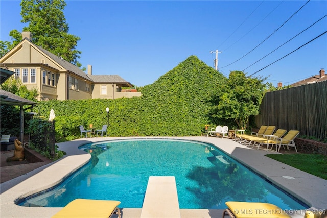 1225 E 18th St, Tulsa, OK 74120 - view of swimming pool featuring a diving board, a fenced backyard, and a patio area