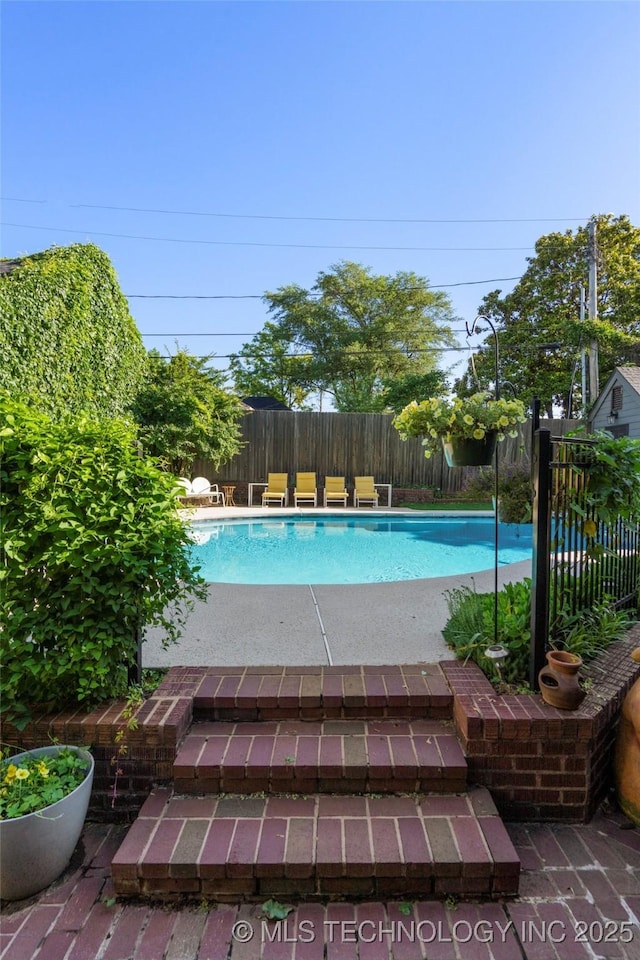 1225 E 18th St, Tulsa, OK 74120 - view of swimming pool with a fenced backyard and a patio