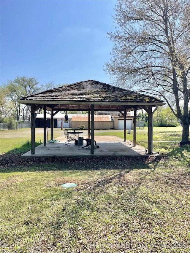 view of home's community featuring fence, a gazebo, a patio area, and a yard