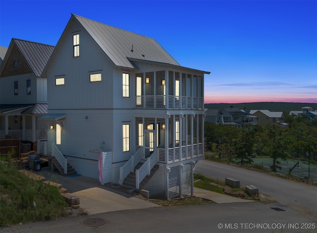 101 Lower Greenway, Carlton Landing, OK 74432 - view of front facade featuring a sunroom, a standing seam roof, and metal roof