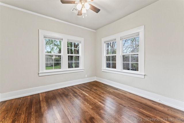 unfurnished room featuring a ceiling fan, dark wood-type flooring, baseboards, and a wealth of natural light