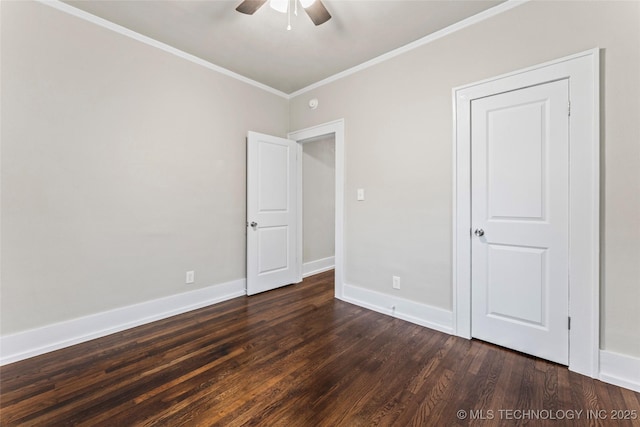 unfurnished bedroom with baseboards, ceiling fan, crown molding, and dark wood finished floors