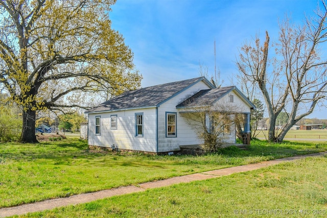 311 SW 4th St, Antlers, OK 74523 - view of property exterior featuring a shingled roof and a lawn