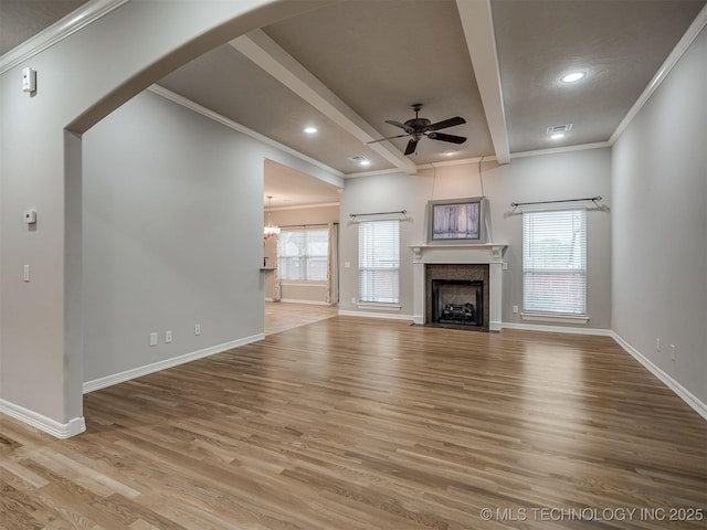 unfurnished living room with baseboards, ceiling fan, light wood-type flooring, and ornamental molding