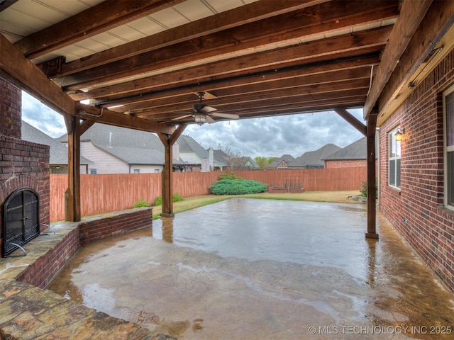 view of patio with a fenced backyard and ceiling fan