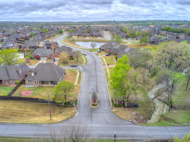bird's eye view with a water view and a residential view