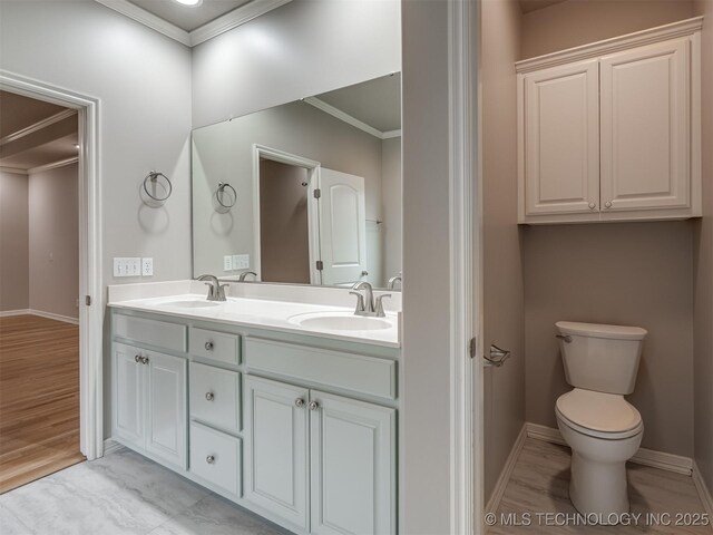 full bathroom featuring double vanity, a sink, and crown molding