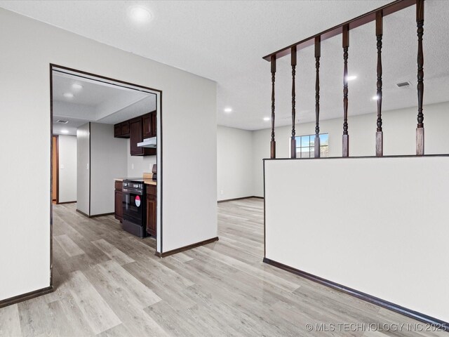 208 NE Spruce Ave, Bartlesville, OK 74006 - unfurnished living room with baseboards, visible vents, recessed lighting, and light wood-type flooring