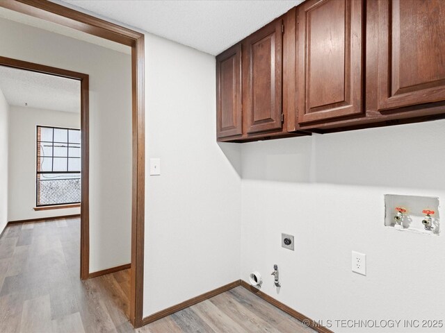 208 NE Spruce Ave, Bartlesville, OK 74006 - laundry room featuring hookup for a gas dryer, light wood finished floors, washer hookup, electric dryer hookup, and cabinet space