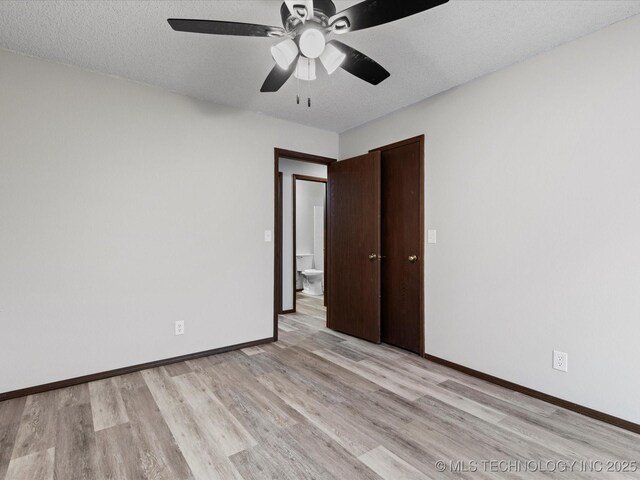 208 NE Spruce Ave, Bartlesville, OK 74006 - spare room with light wood finished floors, a textured ceiling, baseboards, and a ceiling fan
