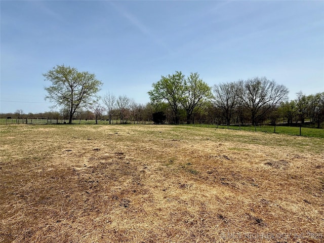 view of yard featuring fence and a rural view