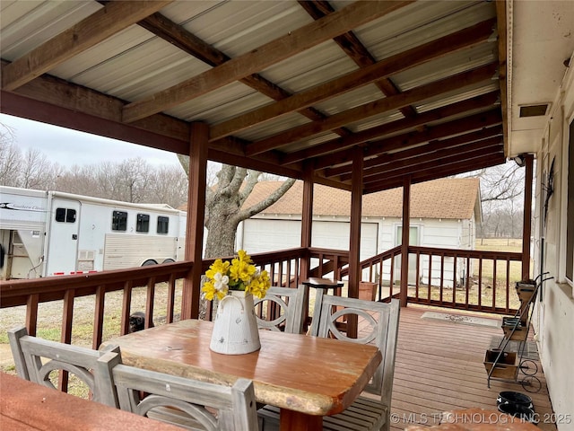 deck featuring outdoor dining space and visible vents