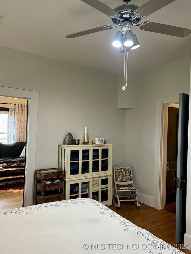 bedroom with baseboards, wood finished floors, and ceiling fan