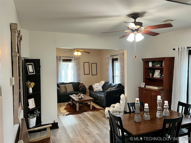 dining space featuring visible vents, light wood-style flooring, and a ceiling fan