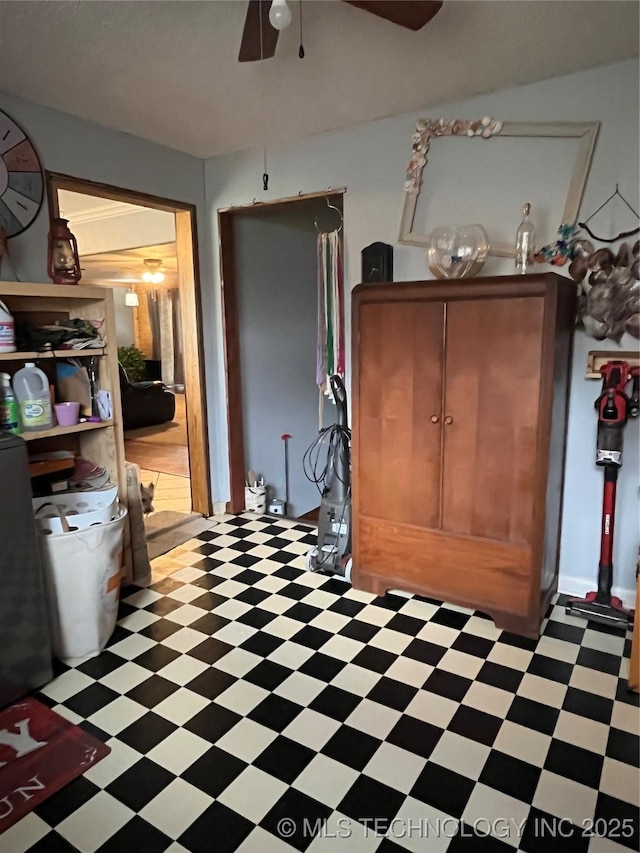 interior space with light floors and a ceiling fan