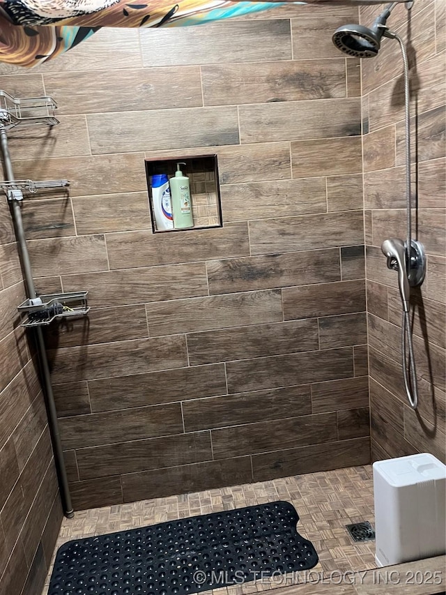 bathroom with a tile shower