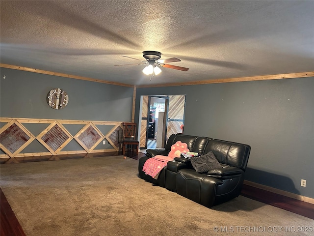 interior space featuring carpet, a ceiling fan, baseboards, and a textured ceiling
