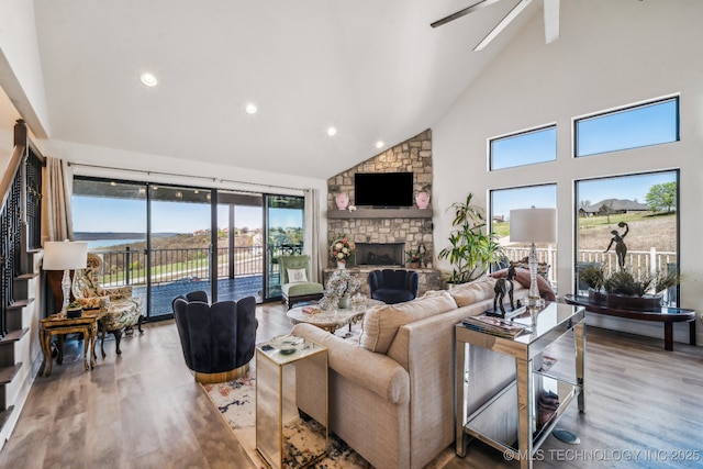 12255 Avalon Dr, Sperry, OK 74073 - living area with high vaulted ceiling, wood finished floors, a ceiling fan, a fireplace, and recessed lighting