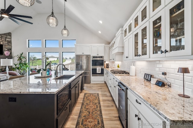 12255 Avalon Dr, Sperry, OK 74073 - kitchen featuring stainless steel appliances, open floor plan, ceiling fan, white cabinets, and light wood-type flooring