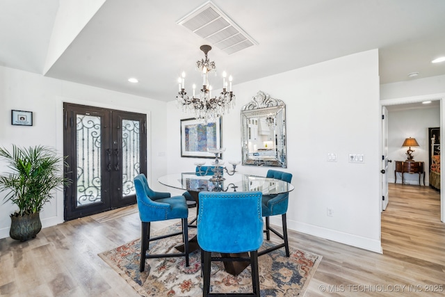 12255 Avalon Dr, Sperry, OK 74073 - dining area with french doors, light wood-style floors, a chandelier, and recessed lighting