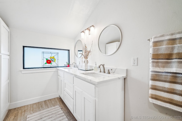 12255 Avalon Dr, Sperry, OK 74073 - bathroom featuring wood finished floors, double vanity, and vaulted ceiling