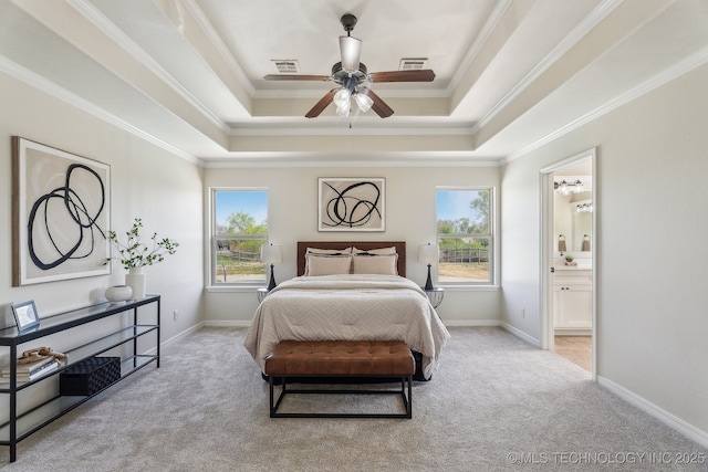 bedroom with a tray ceiling, crown molding, carpet flooring, and visible vents