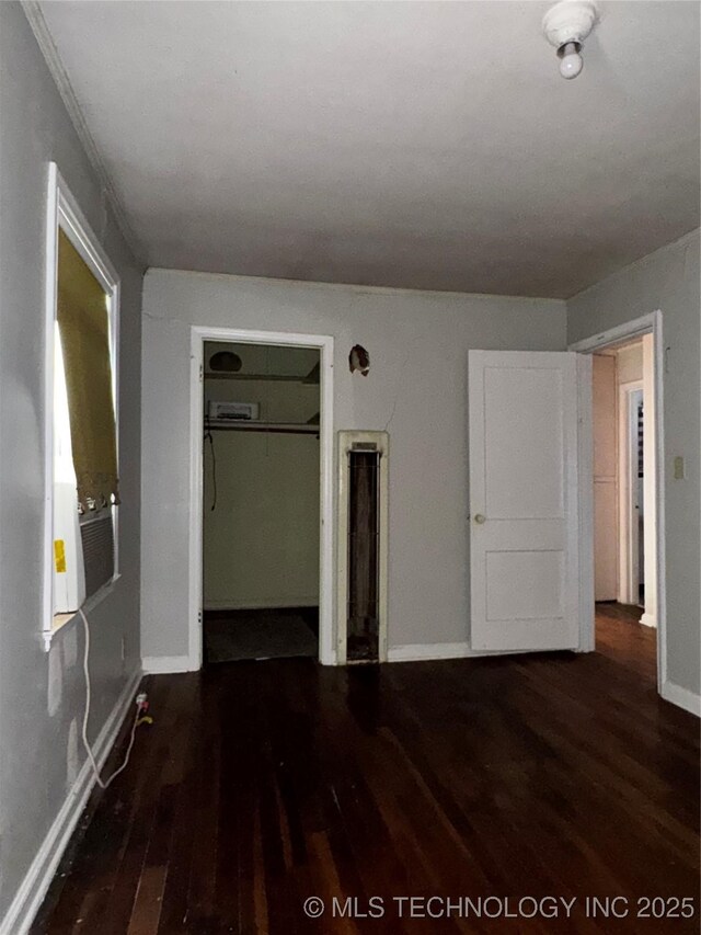 1562 S Hickory Ave, Bartlesville, OK 74003 - unfurnished bedroom featuring wood finished floors, baseboards, and a closet