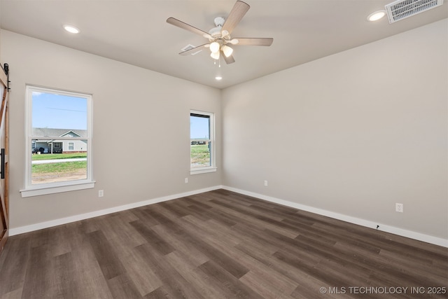 empty room featuring visible vents, ceiling fan, and baseboards