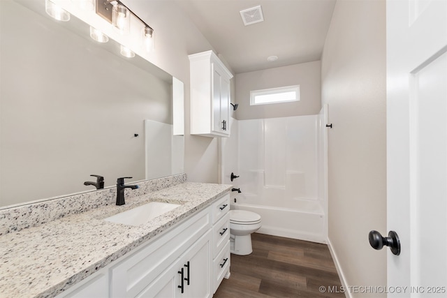 bathroom featuring visible vents, toilet, shower / bath combination, vanity, and wood finished floors