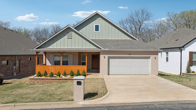 3306 Harbour Town Pl, Claremore, OK 74019 - view of front of house featuring an attached garage, board and batten siding, driveway, a shingled roof, and a porch