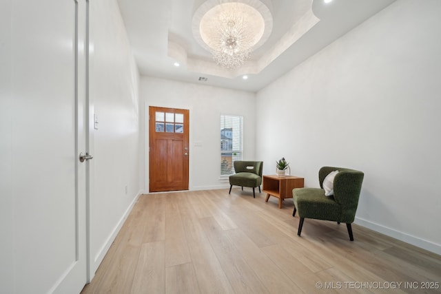 3306 Harbour Town Pl, Claremore, OK 74019 - entryway with a raised ceiling, baseboards, a chandelier, and light wood-type flooring
