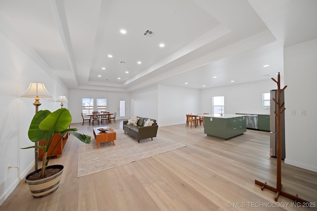 3306 Harbour Town Pl, Claremore, OK 74019 - living area with a tray ceiling, light wood-type flooring, baseboards, visible vents, and recessed lighting