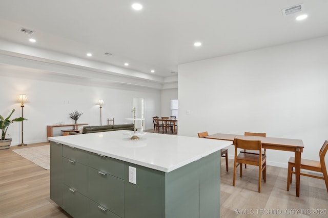 3306 Harbour Town Pl, Claremore, OK 74019 - kitchen with green cabinetry, a kitchen island, recessed lighting, and visible vents