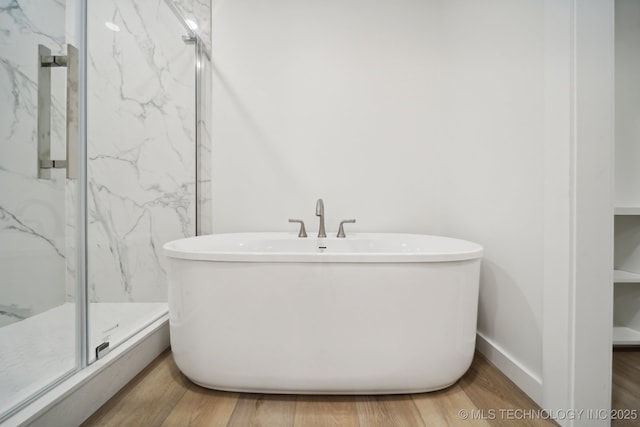 3306 Harbour Town Pl, Claremore, OK 74019 - bathroom with a soaking tub, baseboards, wood finished floors, and a marble finish shower