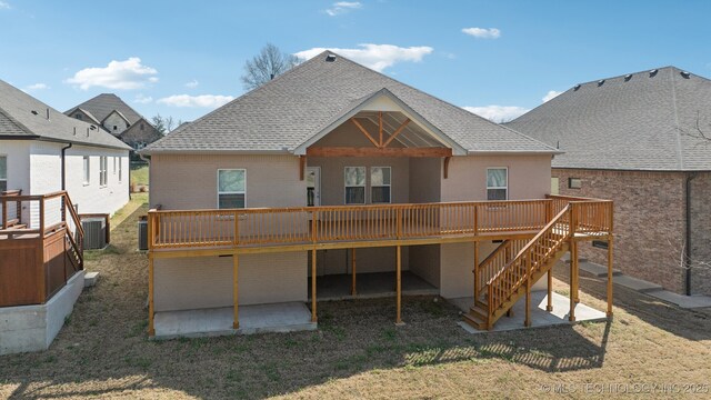 3306 Harbour Town Pl, Claremore, OK 74019 - rear view of house with brick siding, a wooden deck, roof with shingles, and a patio area