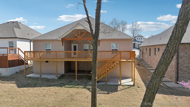 3306 Harbour Town Pl, Claremore, OK 74019 - back of house featuring stairs, a deck, brick siding, a patio, and a lawn